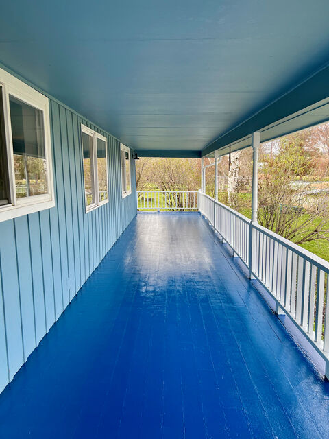 Porch repainted in vivid blue