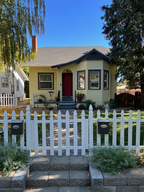 House exterior repaint with white picket fence (after)